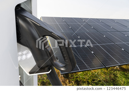 Close up of electric car charging station on the background of solar panels. 123446475