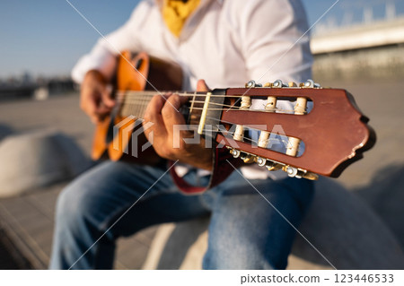 Street musician plays the guitar. Close up 123446533