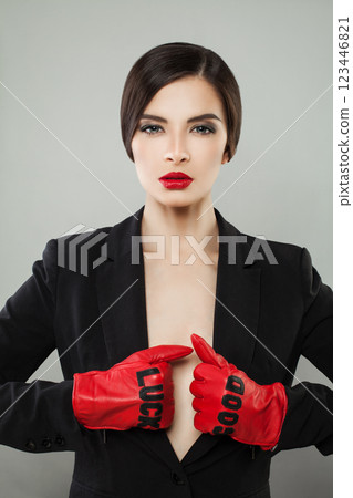 Gorgeous fashionable woman with make-up and dark hair wearing red leather gloves  123446821
