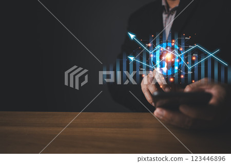 A person holding global and graph stock to plan in e-business, the use of online digital network technology in business, buying and selling commerce online digital marketplace A person holding global and graph stock to plan in e-business, the use of online digital network technology in business, buying and selling commerce online digital marketplace 123446896