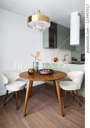 An Impressive Chic Dining Area Showcasing Modern Decor Alongside Elegant Lighting Features 123447017