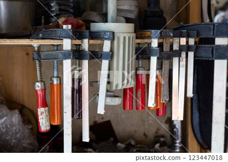A variety of assorted hand tools elegantly arranged and hanging in a functional workshop 123447018