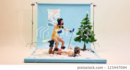 Woman in gold swimsuit with ski gear standing on man back as makeshift snowboard, using ski poles for balance, both engaging in humorous winter adventure Woman in gold swimsuit with ski gear standing on man back as makeshift snowboard, using ski poles for balance, both engaging in humorous winter adventure 123447094