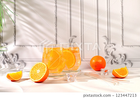 Modern still life with citrus fruits, orange juice and oranges on elegant kitchen table with long hard shadows, minimal detox diet concept, summer vitamin drinks, selective focus, Modern still life with citrus fruits, orange juice and oranges on elegant kitchen table with long hard shadows, minimal detox diet concept, summer vitamin drinks, selective focus, 123447213