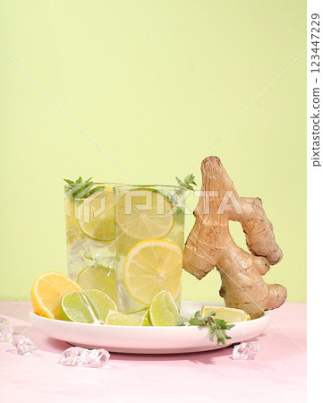 Detox drink with lemon, mint, lime and orange on a light table, mojito or cocktail improves metabolism and promotes weight loss and strengthens immunity, healthy lifestyle concept, selective focus 123447229