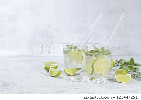 Detox drink with mint, lime and orange on a light table, majito or cocktail improves metabolism and promotes weight loss, healthy lifestyle concept, selective focus 123447251