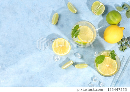 Detox drink with lemon, mint, lime and orange on a light table, majito or cocktail improves metabolism and promotes weight loss, healthy lifestyle concept, selective focus Detox drink with lemon, mint, lime and orange on a light table, majito or cocktail improves metabolism and promotes weight loss, healthy lifestyle concept, selective focus 123447253