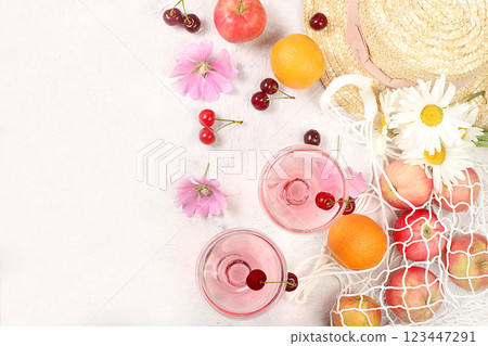 Summer trendy banner on bright background.Straw hat,fruits in eco bag,refreshing alcoholic drinks and chamomile flowers on sunny table.Vacation and travel concept,outdoor camping and holiday party.Top Summer trendy banner on bright background.Straw hat,fruits in eco bag,refreshing alcoholic drinks and chamomile flowers on sunny table.Vacation and travel concept,outdoor camping and holiday party.Top 123447291