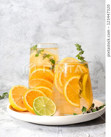 Concept of detox diet and body cleansing. Refreshing homemade lemonade cocktail with fresh lemon, lime, orange and mint. Fruit juice and ingredients, weight loss concept, healthy and natural food, Concept of detox diet and body cleansing. Refreshing homemade lemonade cocktail with fresh lemon, lime, orange and mint. Fruit juice and ingredients, weight loss concept, healthy and natural food, 123447320