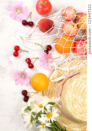 Summer fashion banner on a bright background. Straw hat, fruits and berries in an eco-bag and chamomile flowers on a sunny table. Vacation and travel concept, outdoor camping and holiday party, Summer fashion banner on a bright background. Straw hat, fruits and berries in an eco-bag and chamomile flowers on a sunny table. Vacation and travel concept, outdoor camping and holiday party, 123447322