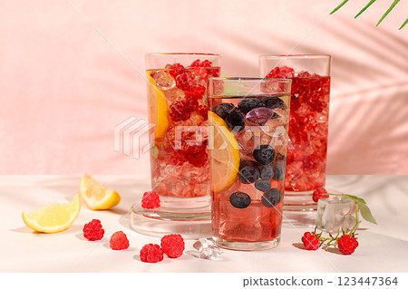 Detox water with fruit flavor on a light background. Refreshing summer homemade lemonade cocktail, mojito with raspberries, currants, mint and lemon, weight loss concept, healthy and natural food, Detox water with fruit flavor on a light background. Refreshing summer homemade lemonade cocktail, mojito with raspberries, currants, mint and lemon, weight loss concept, healthy and natural food, 123447364
