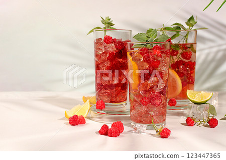 Detox water with fruit flavor on a light background. Refreshing summer homemade lemonade cocktail, mojito with raspberries, currants, mint and lemon, weight loss concept, healthy and natural food, Detox water with fruit flavor on a light background. Refreshing summer homemade lemonade cocktail, mojito with raspberries, currants, mint and lemon, weight loss concept, healthy and natural food, 123447365