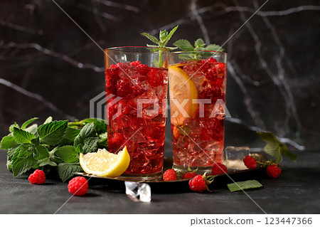 Refreshing summer homemade lemonade cocktail, mojito with raspberries, currants, mint and lemon, fruit flavored detox water, weight loss concept, healthy and natural food, selective focus 123447366