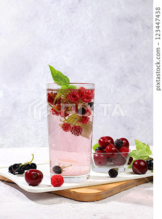 Detox water with fruit flavor on a light background. A refreshing homemade lemonade cocktail. Fruit juice and ingredients, weight loss concept, healthy and natural food, selective focus Detox water with fruit flavor on a light background. A refreshing homemade lemonade cocktail. Fruit juice and ingredients, weight loss concept, healthy and natural food, selective focus 123447438
