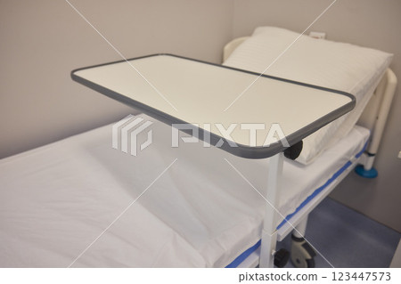 A Hospital Bed located within a Medical Facility designed for patient comfort and care A Hospital Bed located within a Medical Facility designed for patient comfort and care 123447573