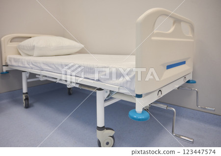 A Hospital Bed located within a Medical Facility designed for patient comfort and care A Hospital Bed located within a Medical Facility designed for patient comfort and care 123447574