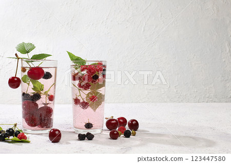 Detox fruit flavored water on a light background. Refreshing summer homemade lemonade cocktail. Fruit juice and ingredients, weight loss concept, healthy and natural food, selective focus Detox fruit flavored water on a light background. Refreshing summer homemade lemonade cocktail. Fruit juice and ingredients, weight loss concept, healthy and natural food, selective focus 123447580