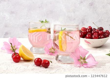 Cherry iced tea or mint and lemon cocktail, a refreshing summer drink recipe. Glass with apple fruit lemonade on light concrete table, detox diet and weight loss concept, restaurant menu 123447612