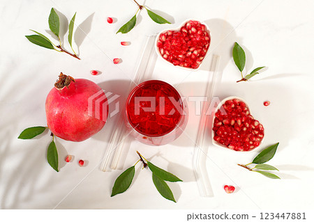 Fruit pomegranate juice and ingredients, summer pomegranate drink on bright table, detox diet and weight loss concept, healthy and natural food, source of vitamin C, selective focus, space for text Fruit pomegranate juice and ingredients, summer pomegranate drink on bright table, detox diet and weight loss concept, healthy and natural food, source of vitamin C, selective focus, space for text 123447881