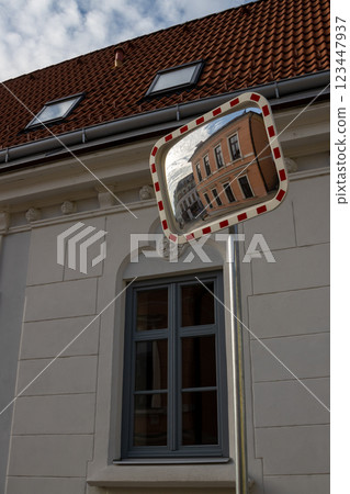 Orange classic building in a traffic mirror, Czechia 123447937