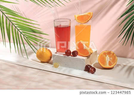 Modern still life with citrus, orange and grape juice, oranges and grapes on a pastel background with long hard shadows, minimal detox diet concept, summer vitamin drinks, selective focus, space for 123447985