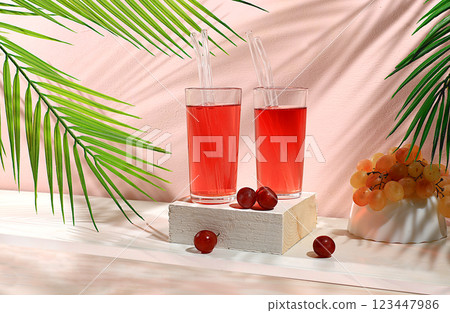 Modern still life with grape juice and grapes on pastel background with shadows, minimal detox diet concept, summer party advertisement with vitamin drinks, selective focus, space for text Modern still life with grape juice and grapes on pastel background with shadows, minimal detox diet concept, summer party advertisement with vitamin drinks, selective focus, space for text 123447986