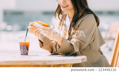 A smiling woman eating lunch on a terrace 123448110