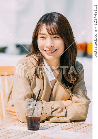 Smiling woman drinking coffee on the terrace 123448113