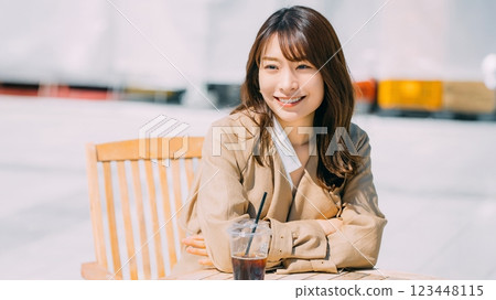 Smiling woman drinking coffee on the terrace Smiling woman drinking coffee on the terrace 123448115