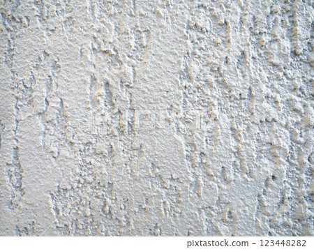 Rough light surface. Background from a stone wall. Cement stains. House cladding. 123448282