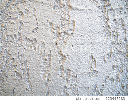 Rough light surface. Background from a stone wall. Cement stains. House cladding. 123448283