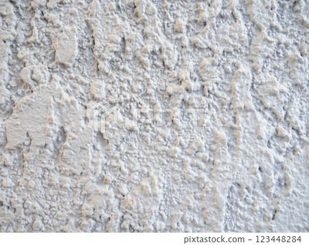 Rough light surface. Background from a stone wall. Cement stains.   White background 123448284