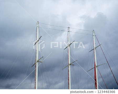masts of a ship without sails. The sails are down. Overcast sky. masts of a ship without sails. The sails are down. Overcast sky. 123448366