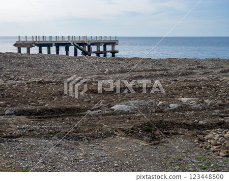 Repair of the embankment of the seaside resort. Preparing for the tourist season. Leveling the ground on the beach. 123448800
