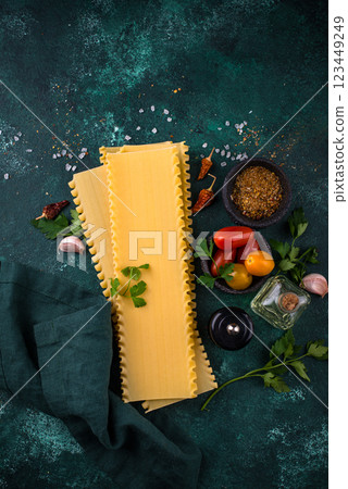 Uncooked lasagna pasta with cooking ingredient Uncooked lasagna pasta with cooking ingredient 123449249