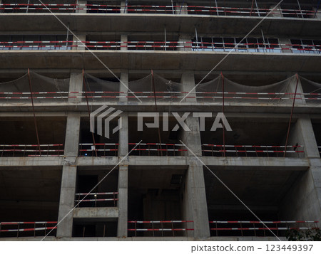 Construction of a tall building. Safety net at a construction site. Safety. Reinforced concrete building. Construction of a tall building. Safety net at a construction site. Safety. Reinforced concrete building. 123449397