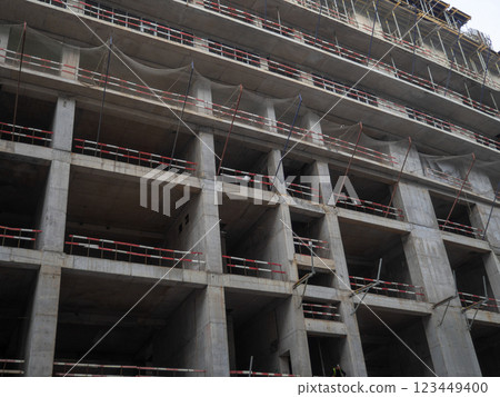 Construction of a tall building. Safety net at a construction site. Safety. Reinforced concrete building. 123449400