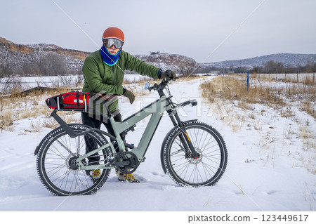 senior male cyclist with a touring electric bike in Colorado foothills in winter scenery 123449617