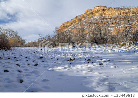 frozen Poudre River and sandstone cliff at Colorado foothills of Rocky Mountains near Fort Collins 123449618