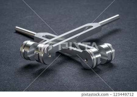 Weighted and unweighted metal tuning forks used for tuning musical instruments, sound therapy, chakra healing or relaxation. 123449712