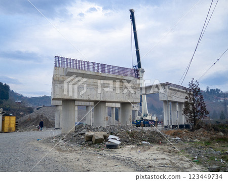 Bridge construction. Bridge supports in the mountains. Interchange construction. Truck crane. 123449734