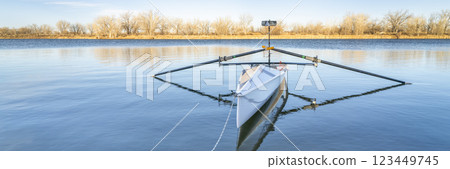 Coastal rowing shell by on a lake in northern Colorado in winter or early spring scenery. Coastal rowing shell by on a lake in northern Colorado in winter or early spring scenery. 123449745
