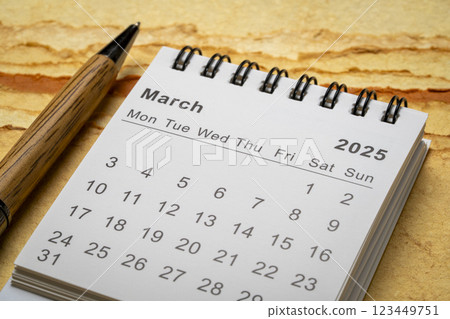 March 2025 - small spiral desktop calendar, time and business concept 123449751