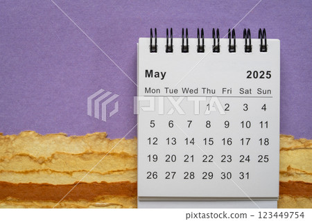 May 2025 - small spiral desktop calendar, time and business concept 123449754
