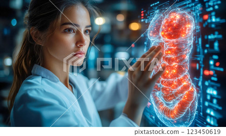 A young female scientist examines a holographic human stomach model in a futuristic medical research facility, illuminated by blue and red digital displays 123450619