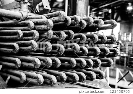 Maintenance being completed on metal piping from boiler coils and tubing  123450705