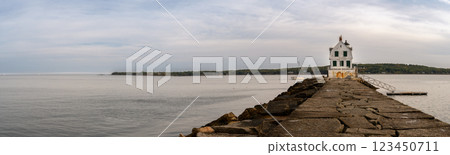 Long walkway leading to the Rockland Breakwater Lighthouse cutting through the harbor on the Gulf of Maine  123450711