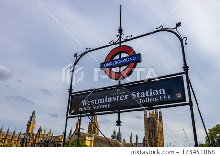 Westminster Station London Underground Sign With Houses of Parliament in the Background 123451068