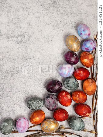 Easter marble eggs dyed with natural hibiscus tea, onion peel and curcumin with a willow branch on a gray concrete background. Easter celebration concept, holiday card and ideas for preparing for the Easter marble eggs dyed with natural hibiscus tea, onion peel and curcumin with a willow branch on a gray concrete background. Easter celebration concept, holiday card and ideas for preparing for the 123451125