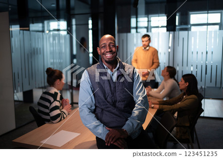 Confident entrepreneur in a startup office, smiling with vision and leadership. Team leader, advisory consultant, and marketing expert at a creative advertising agency workshop 123451235